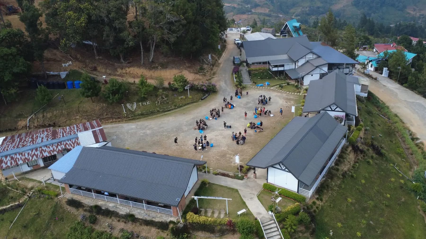 Aerial view of a group doing activities in the courtyard at The Hill Kinabalu