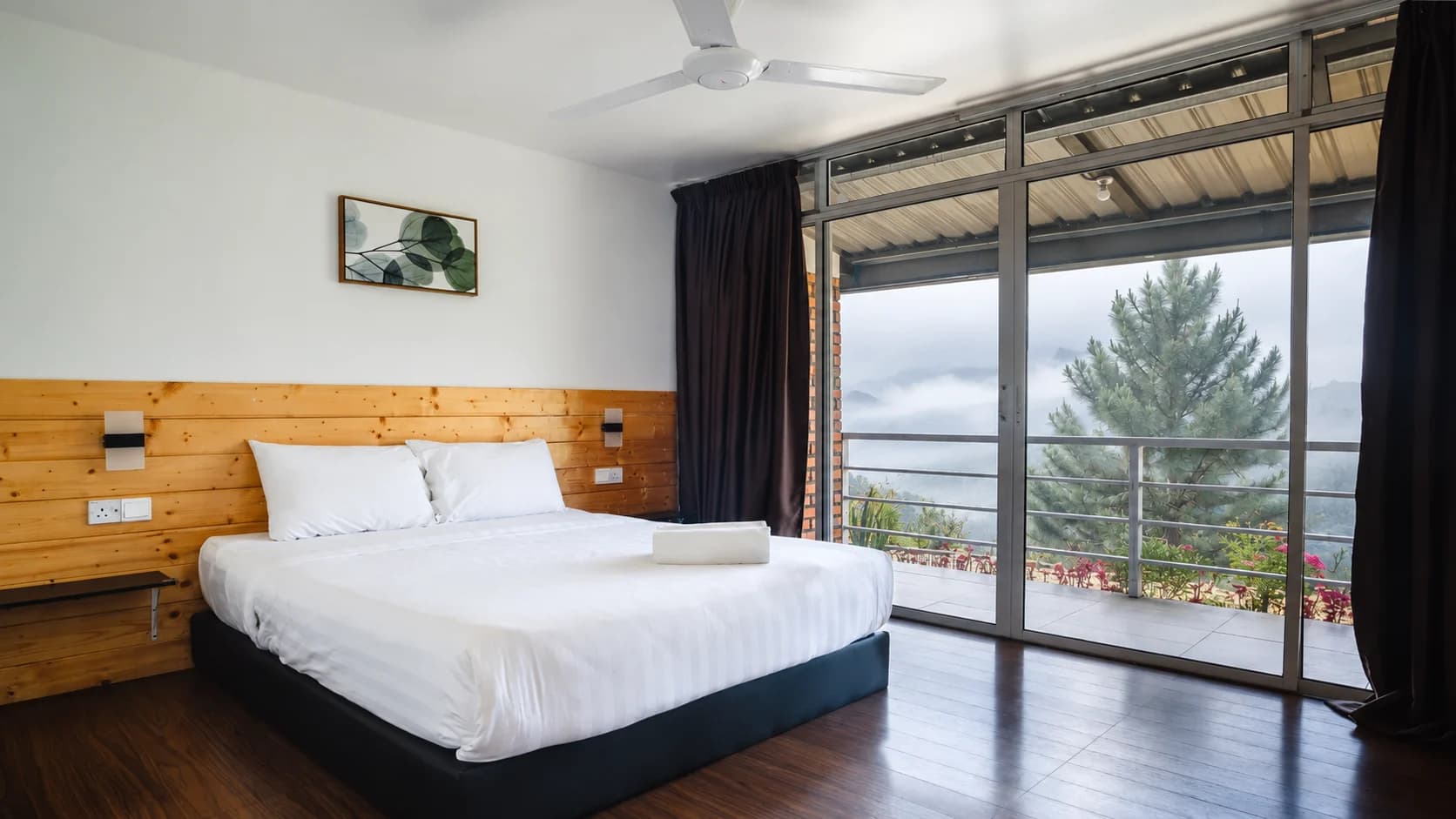 A room at The Hill Kinabalu with mist over the hills outside