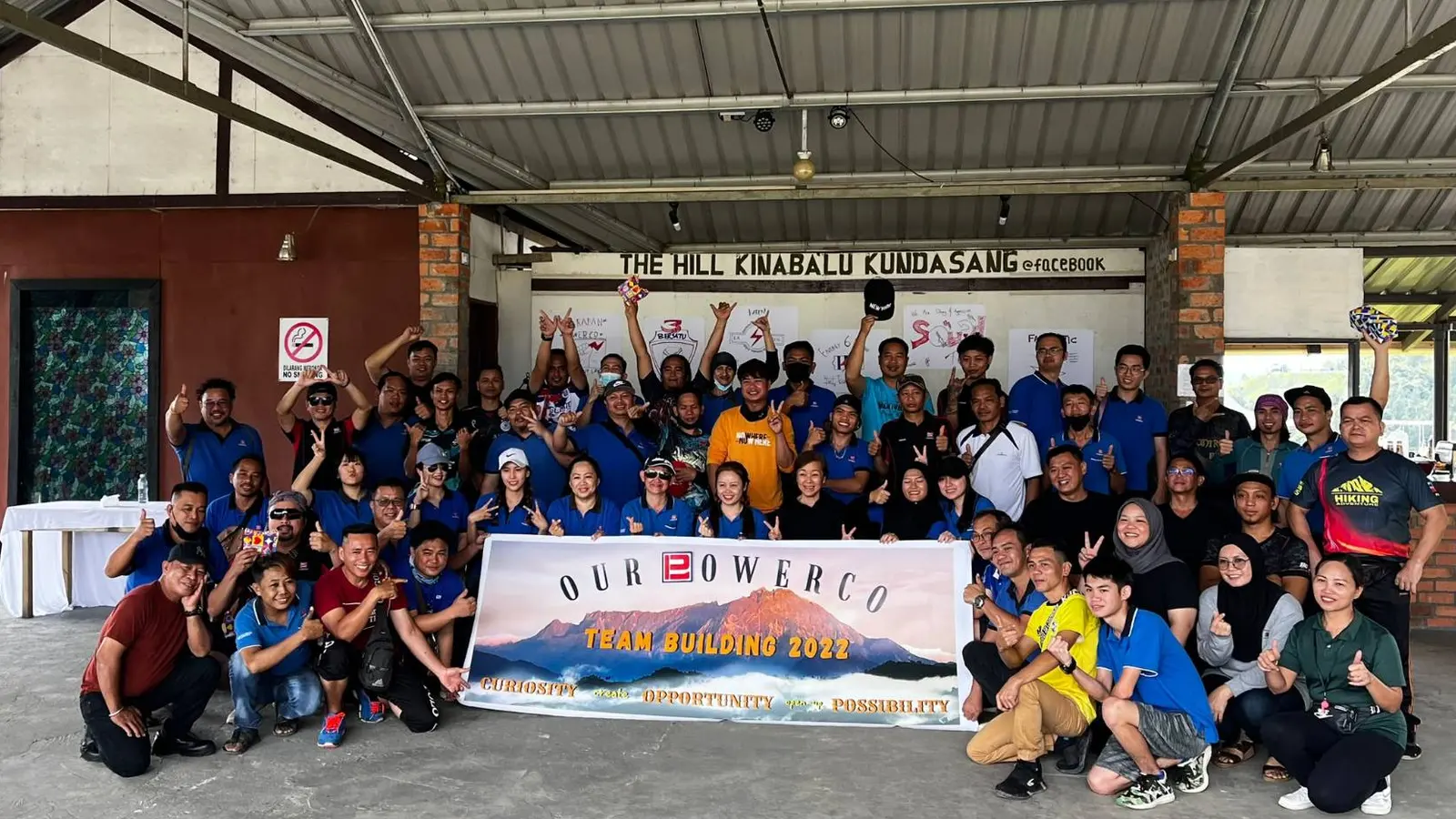 Our Powerco staff with their Team Building 2022 banner in the hall at The Hill Kinabalu